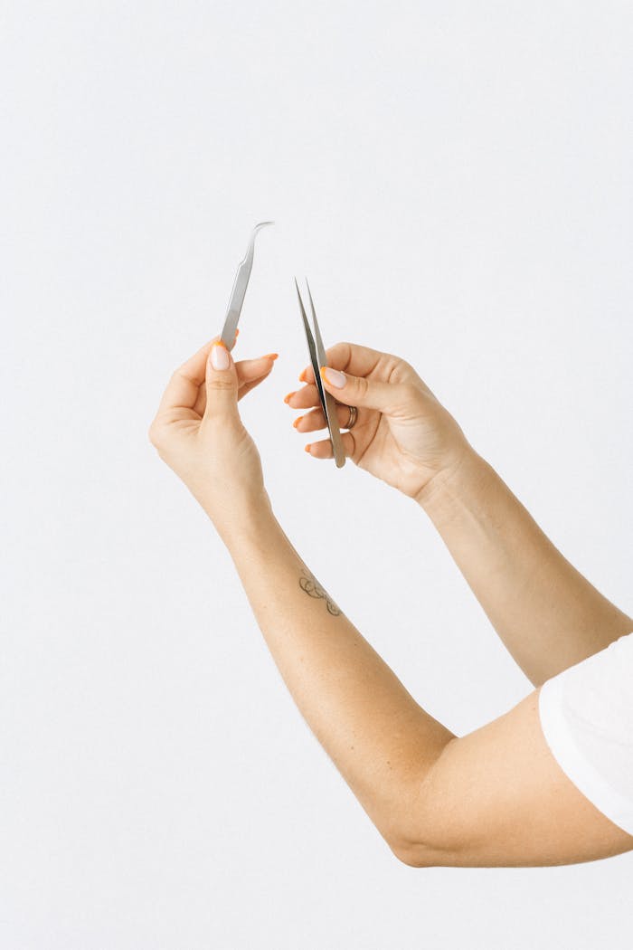 Person Holding Pen Writing on White Paper